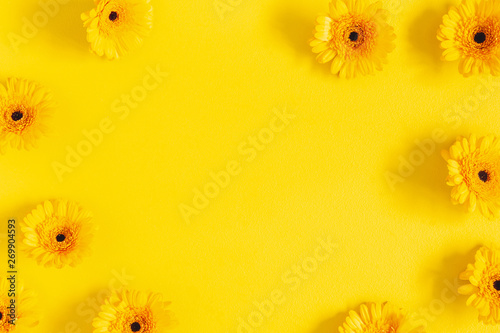 Flowers composition. Yellow gerbera flowers on yellow background. Flat lay, top view, copy space