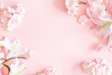 Flowers composition. Pink and white flowers on pastel pink background. Flat lay, top view, copy space