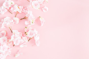 Flowers composition. Hydrangea flowers on pastel pink background. Flat lay, top view, copy space
