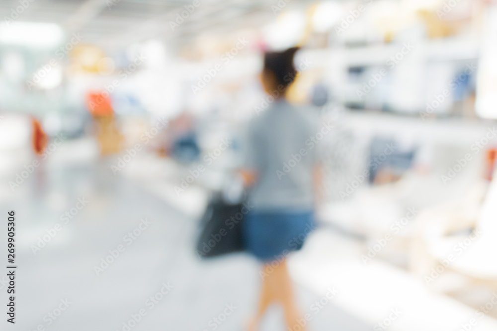 Naklejka premium Blurred bix box store supercenter with customers shopping for home goods.