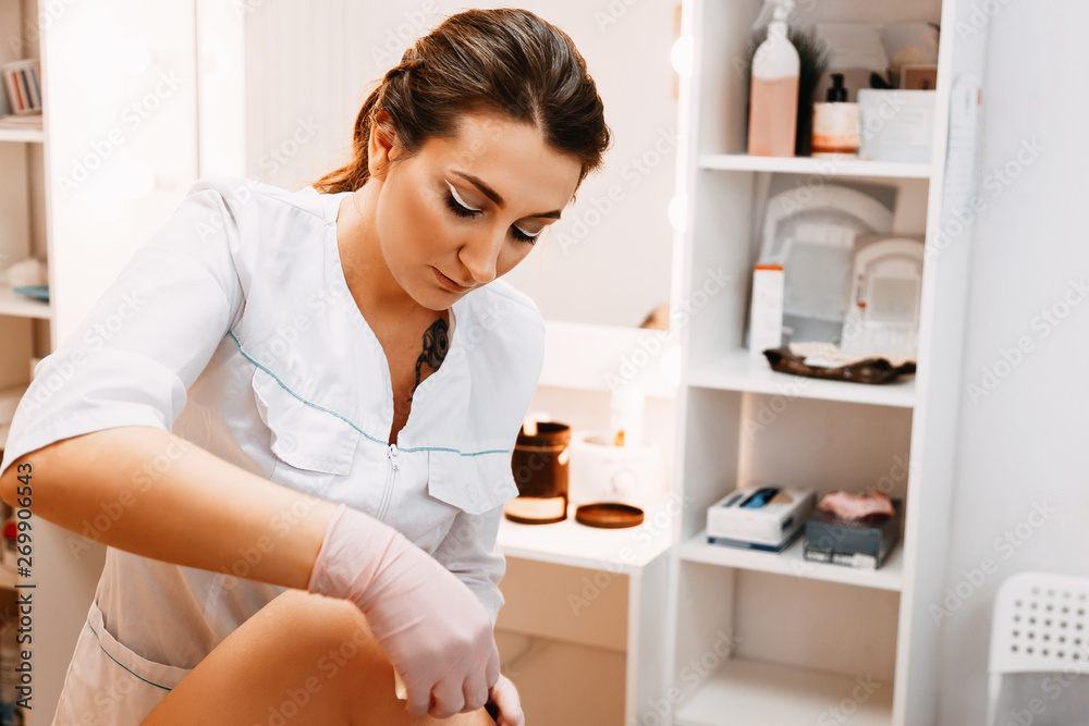 Sugaring: epilation with liquate sugar at legs. Sugaring: epilation with liquate sugar at legs.