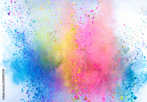 Colored powder explosion on white background. Freeze motion. photo