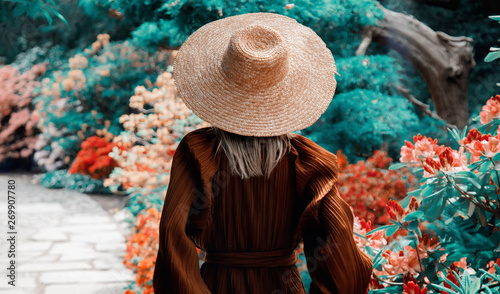 style woman near rhododendron flowers in a grarden in spring time photo