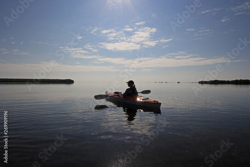 Kayaker enjoying a very calm early morning paddle on Biscayne Bay in Biscayne National Park  Florida