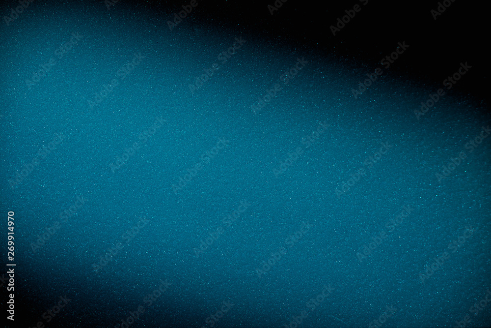 Obraz premium Diagonal blurred cloud of blue on a black background