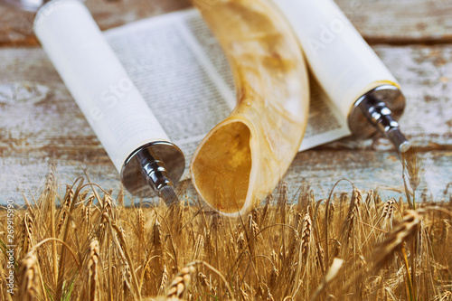 Symbols of jewish holiday Shavuot torah and shofar wooden background. photo