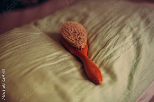 Hairbrush for spanking on pillow. Domestic discipline. Traditional corporal punishment implements. adult role play and sex toys.