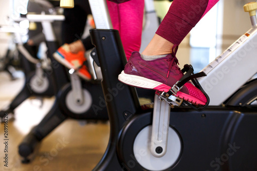 Group of young slim women workout on exercise bike in gym. Sport and wellness lifestyle concept © Kate