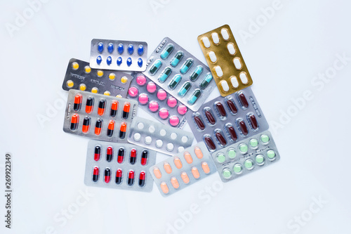 Various capsule medicines, pills and tablets in blister pack on white