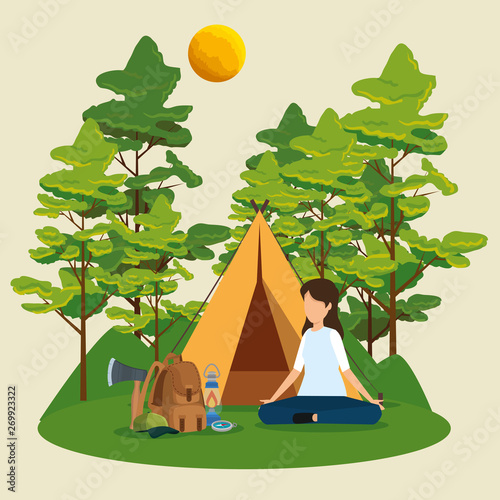 woman with camp and backpack with lamp in the nature trees