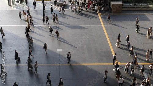 One man stands in middle of Osaka Station transit area as crowds move by