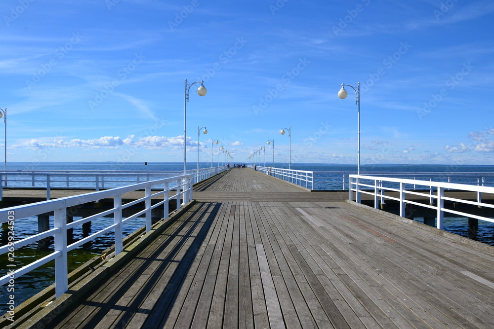 Wooden pier in Jurata town at sunny, summer day. Coast of Baltic Sea at Hel peninsula, Poland