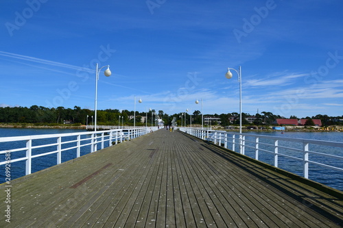 Wooden pier in Jurata town at sunny, summer day. Coast of Baltic Sea at Hel peninsula, Poland