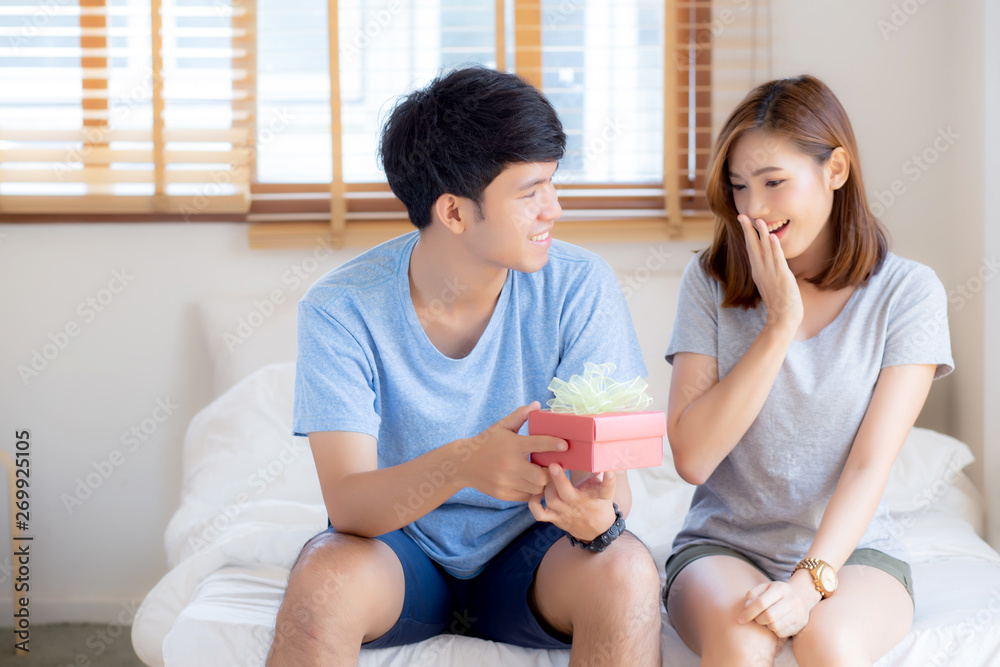 Beautiful young asian couple in love surprise gift box in bedroom at home, family anniversary with enjoy and romantic together wife and husband with relationship, Celebrating Valentine Day concept. Beautiful young asian couple in love surprise gift box in bedroom at home, family anniversary with enjoy and romantic together wife and husband with relationship, Celebrating Valentine Day concept.