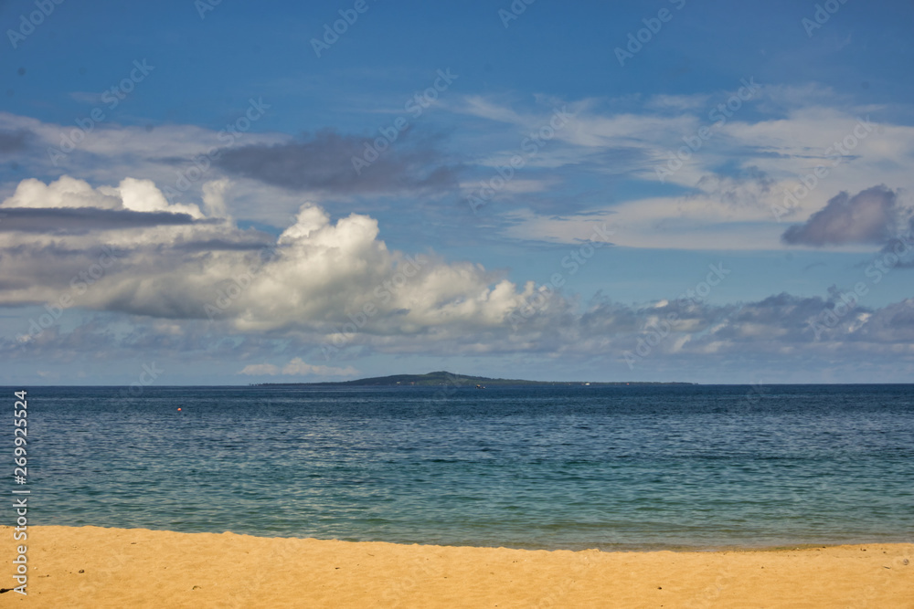 photo of the coast of the sea in summer and clouds in the background