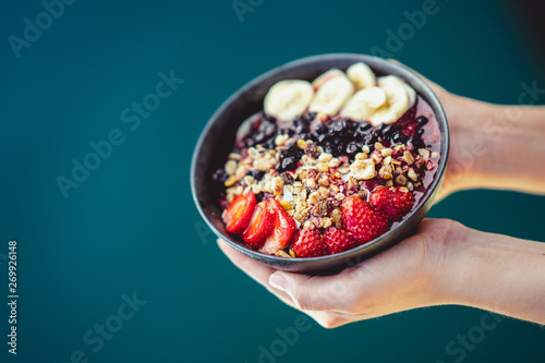 holding bowl of fruit