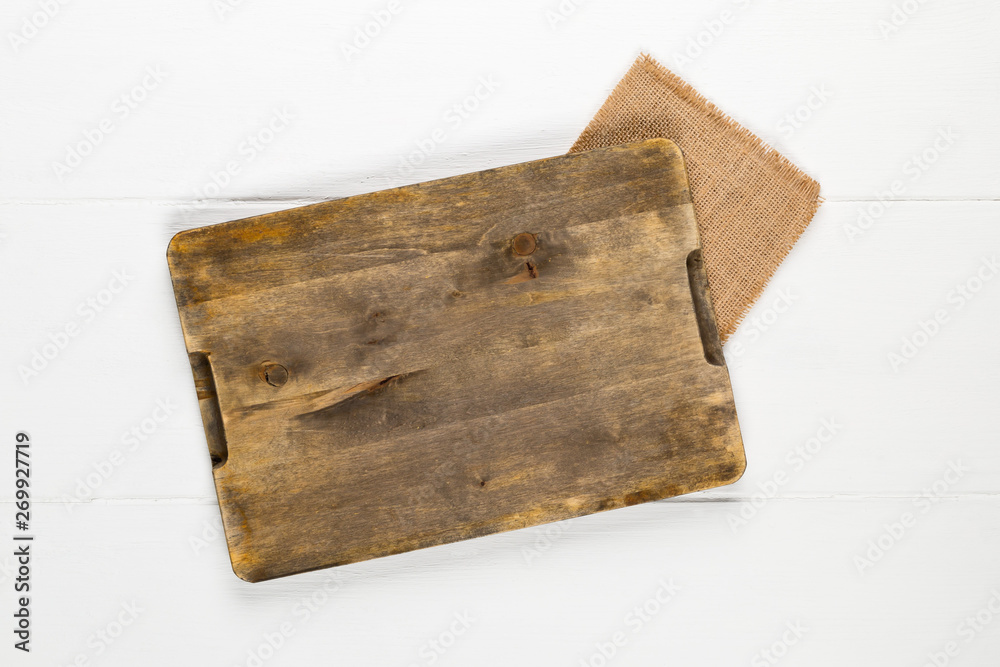 Fototapeta premium Empty cutting board on rustic white wooden table background top view from above
