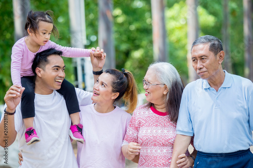 Asian three generation family chatting at outdoors