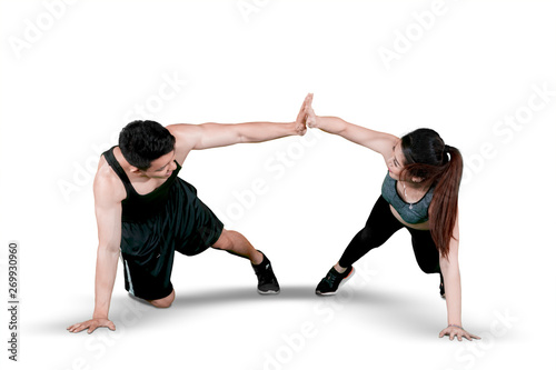 Sporty couple makes high five hand gesture