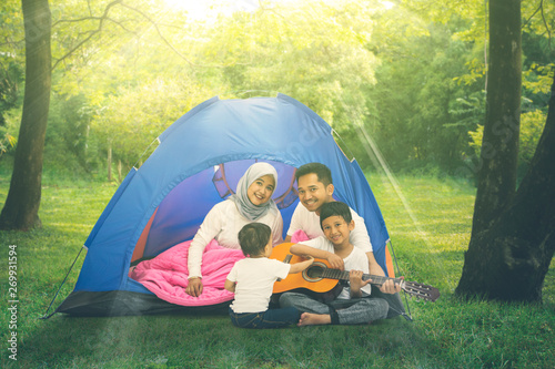 Two children enjoy camping with their parents