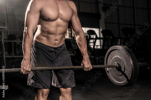 Close up of hands Handsome strong athletic men pumping up muscles workout barbell curl bodybuilding concept background - muscular bodybuilder men doing exercises in dark gym .