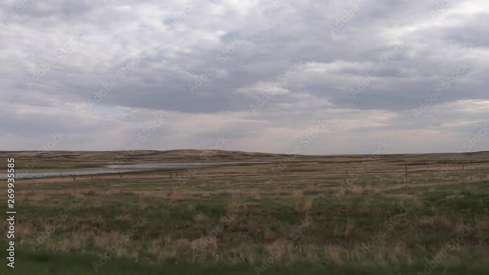 Driving through the country on a cloudy day looking at a green field in Canada. Driving through the country on a cloudy day looking at a green field in Canada.
