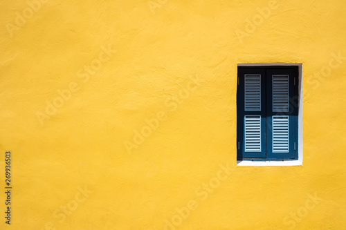Blue window on yellow wall