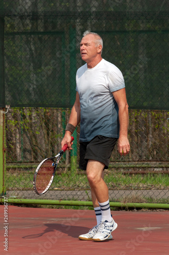 Man playing tennis on the outdoor court © Дворецкая Таня