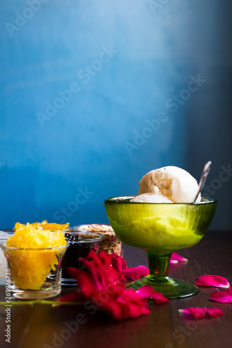 Coconut ice cream with nuts, Grass Jelly, Sticky rice, pineapple and palm seed in small bowl with rose