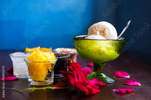 Coconut ice cream with nuts, Grass Jelly, Sticky rice, pineapple and palm seed in small bowl with rose