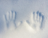 Winter theme two handprints in the snow.
