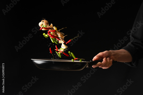 Chef preparing sea food, praying mantis shrimp with lemon and hot pepper and green beans, East Asian cuisine, dilikates, vegetarian cuisine, on a black background, horizontal photo, close-up