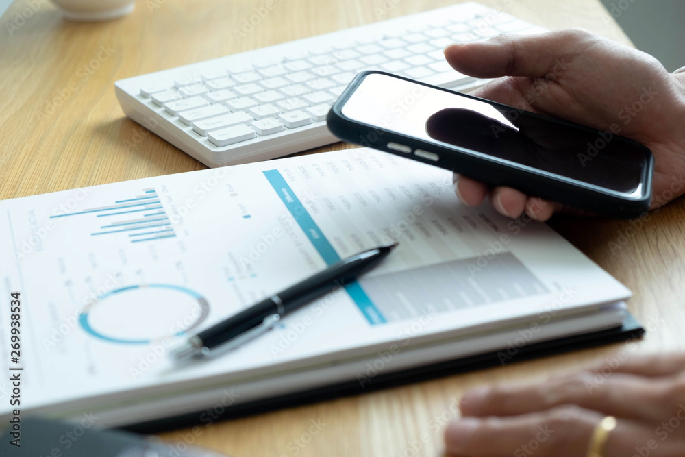 close-up Businessmen financial sitting work checking documents using technology close-up Businessmen financial sitting work checking documents using technology