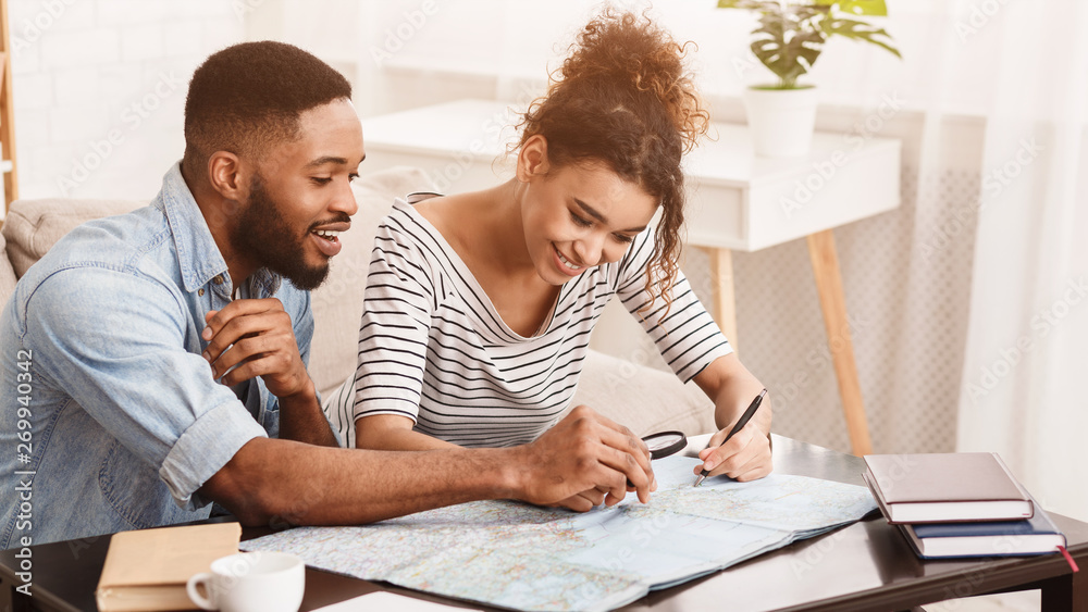 Afro Couple Planning Travel. Searching Best Route On Map