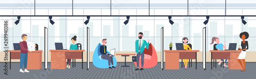 mix race workers in creative co-working open space center working process concept businessmen and businesswomen at workplace modern workspace office interior flat horizontal