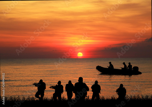  Navy seal silhouettes  on sunrise 