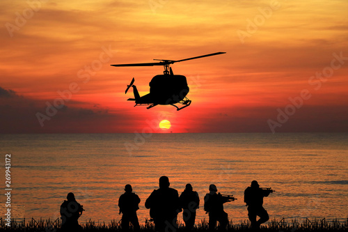  Navy seal silhouettes  on sunrise 