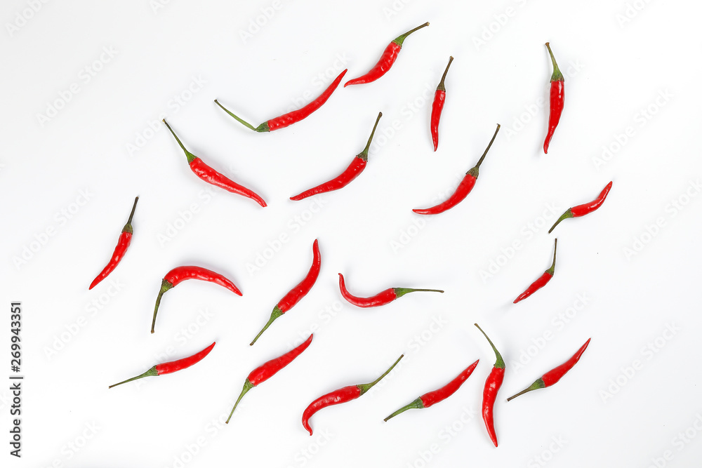 Fresh birds eye red chilli scattered top view on white background Fresh birds eye red chilli scattered top view on white background