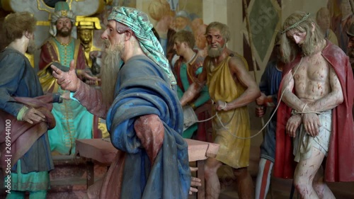 Terracotta sculptures of Jesus Christ on the road to calvary on a biblical character scene representation from a chapel of famous Sacred mountain of Varallo, an Unesco world heritage site photo