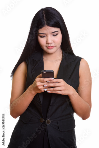 Studio Portrait Of Young Asian Woman Using Phone