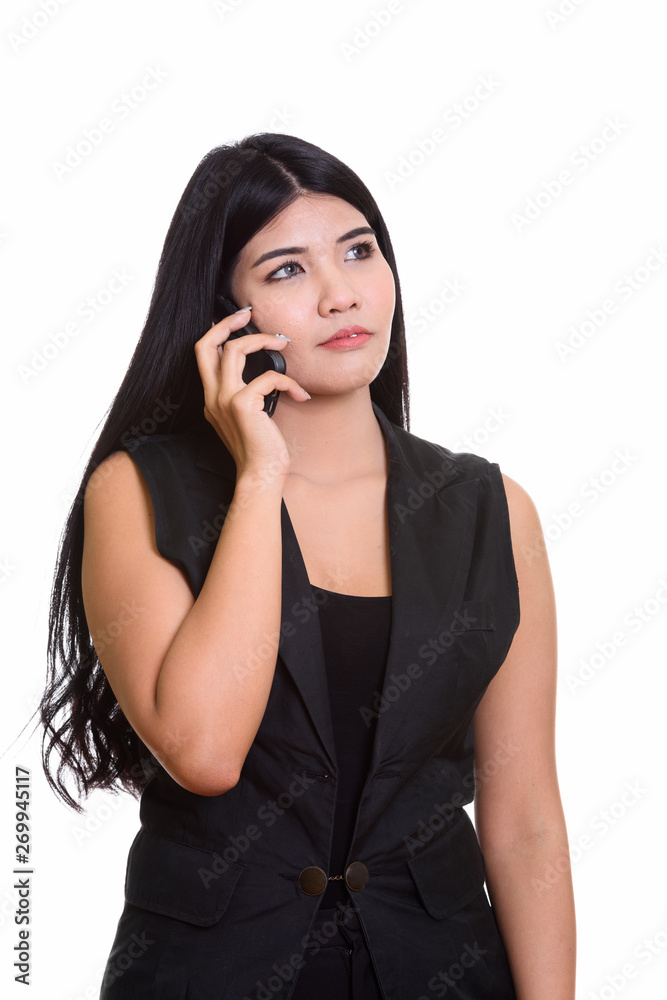 Studio Portrait Of Young Asian Woman Talking On Phone Studio Portrait Of Young Asian Woman Talking On Phone