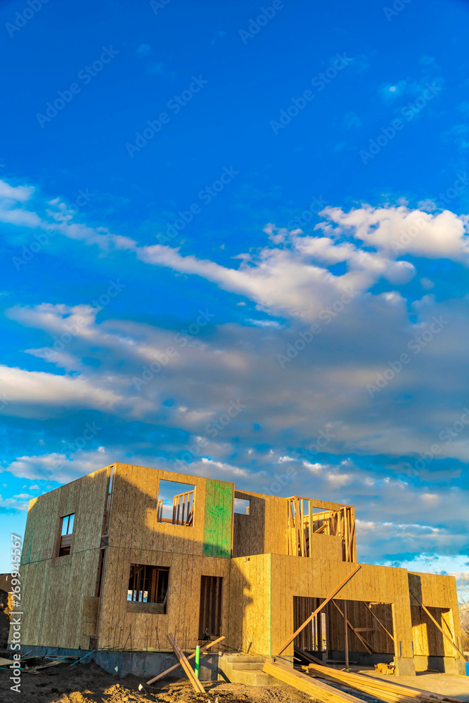 Framework of a house under construction viewed on a bright sunny day Framework of a house under construction viewed on a bright sunny day