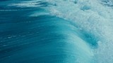 aerial drone closeup image of surf waves breaking over a reef with white water break