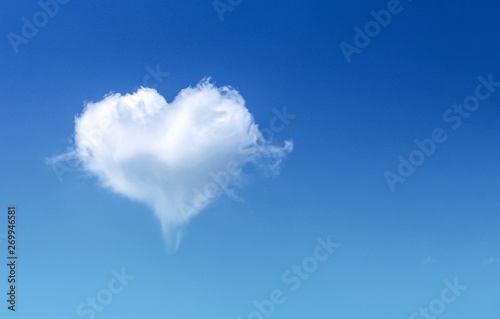 White fluffy heart shaped cloud patterns soft focus on clear blue sky and copy space , Valentines day background