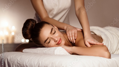 Shoulder Massage. Beautiful Woman Relaxing In Health Spa