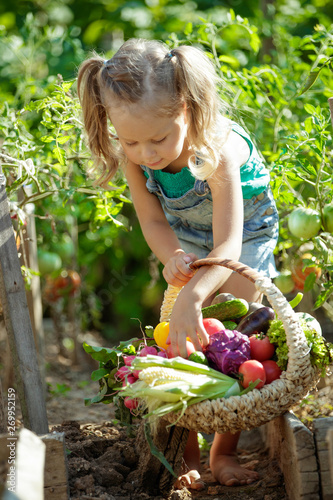 Child with vegetables in nature 