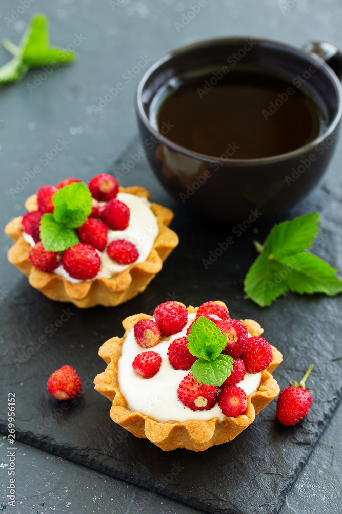 Wild strawberry tartlets with cream filling. delicious summer fruit mini tarts Wild strawberry tartlets with cream filling. delicious summer fruit mini tarts