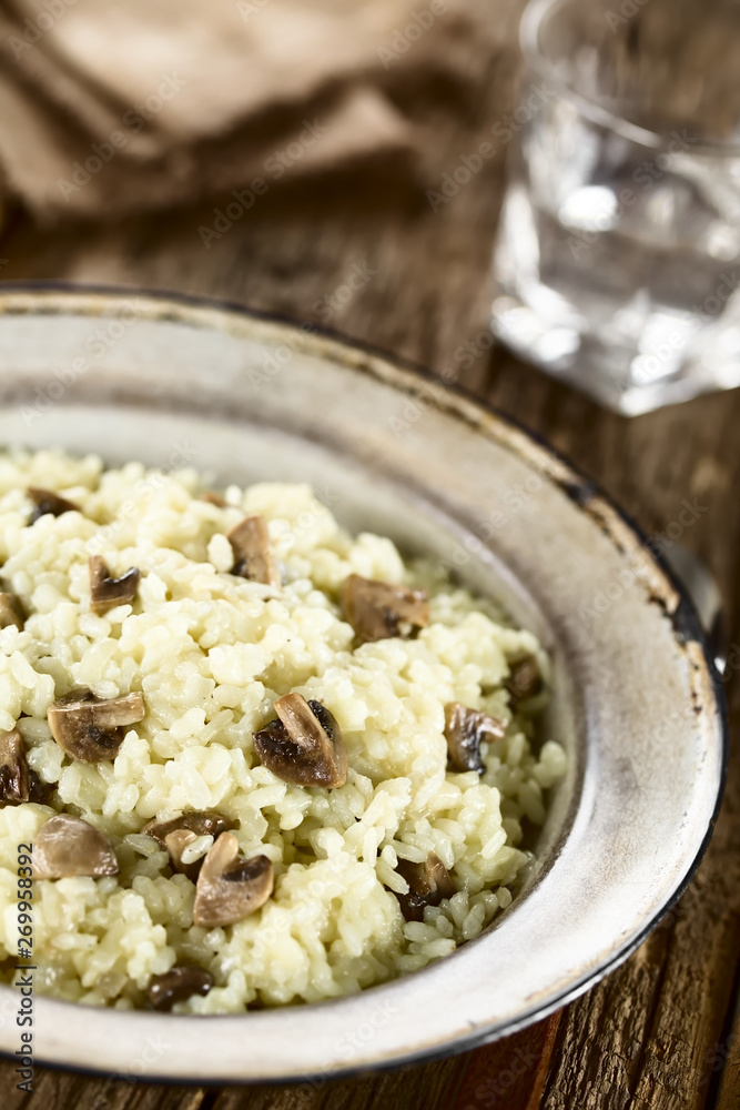 Fresh homemade mushroom risotto on rustic plate (Selective Focus, Focus one third into the image) Fresh homemade mushroom risotto on rustic plate (Selective Focus, Focus one third into the image)
