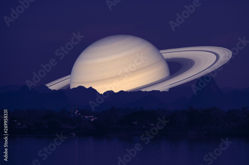 Saturn planet back silhouette river and mountain inght sky background