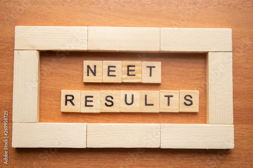 Maski, India 26,May 2019 : NEET or National Eligibility and Entrance Test RESULTS in wooden block letters. photo
